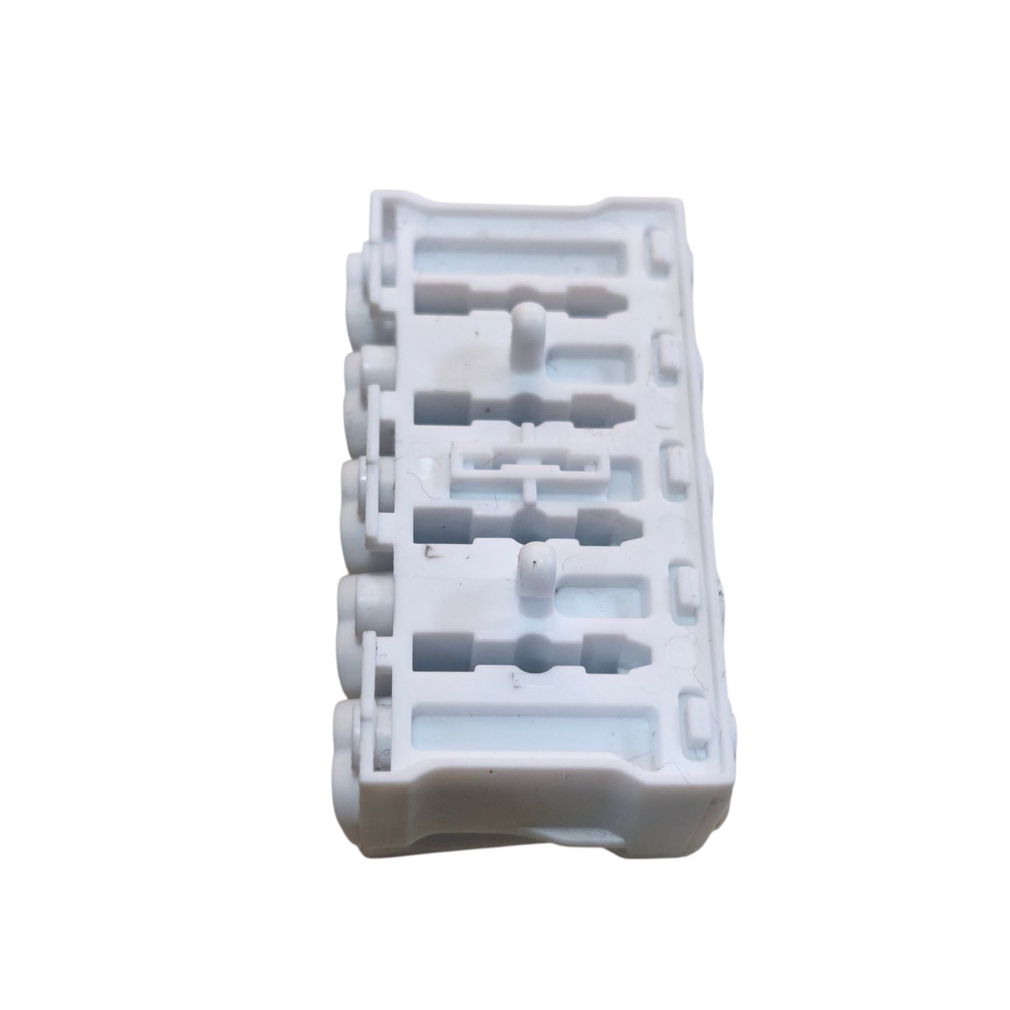 White plastic component with multiple holes on a white background
