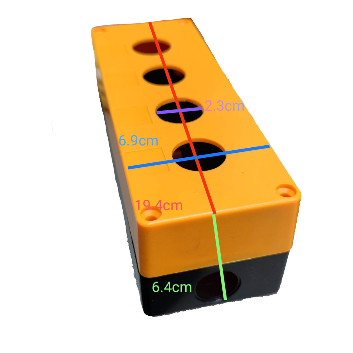 A rectangular orange and black plastic block with four circular holes on top, overlaid with colored measurement lines and labels showing dimensions in centimeters.
