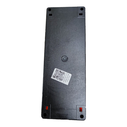 The underside of a black rectangular electronic device, showing a textured plastic surface, a central screw, a white QR code sticker, and small red tabs at the corners.