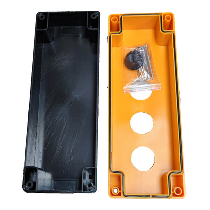 Two plastic electrical junction boxes shown side by side on a white background, one black and one orange, with a small hardware bag containing screws and washers inside the orange box.