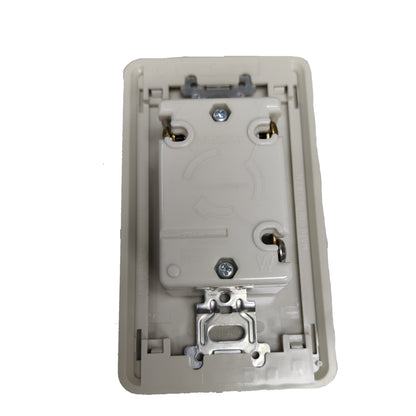 An off-white plastic rear view of a wall switch plate or socket cover with metal screw terminals and a latch mechanism, isolated on a white background.