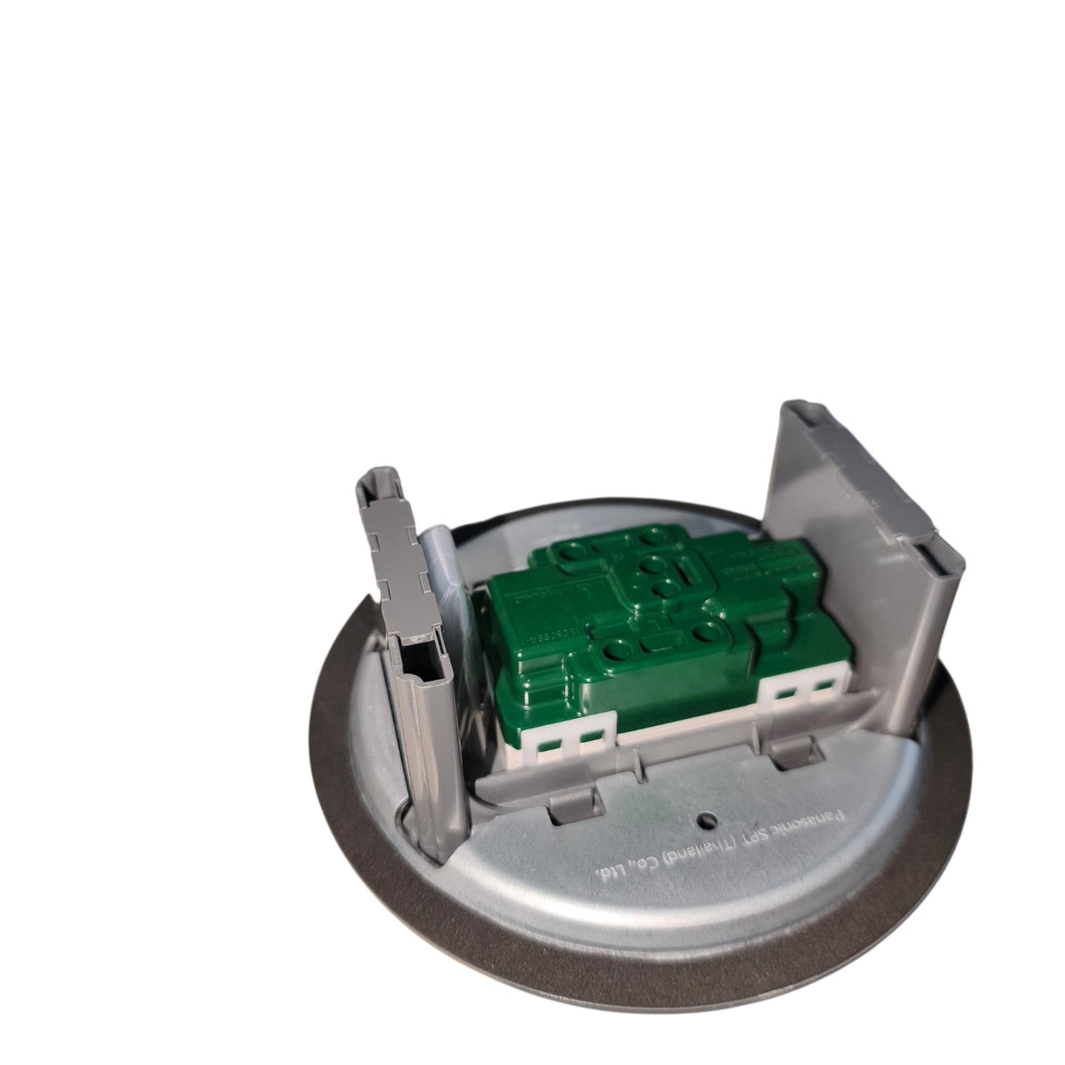 A circular metal recessed light fixture component with a green plastic central module and gray metal brackets, isolated on a white background.