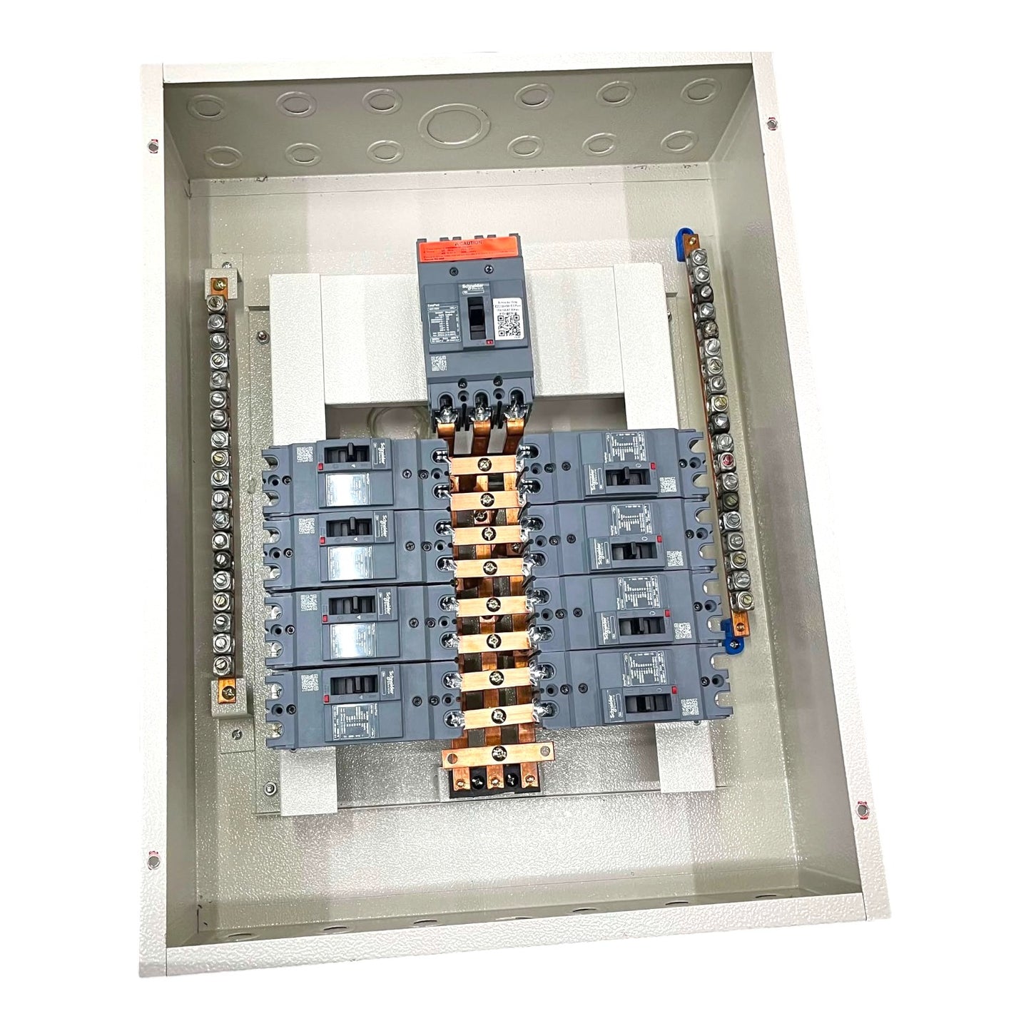 An open industrial electrical distribution panel showing multiple gray circuit breakers, terminal blocks, and a central busbar assembly inside a metal enclosure.