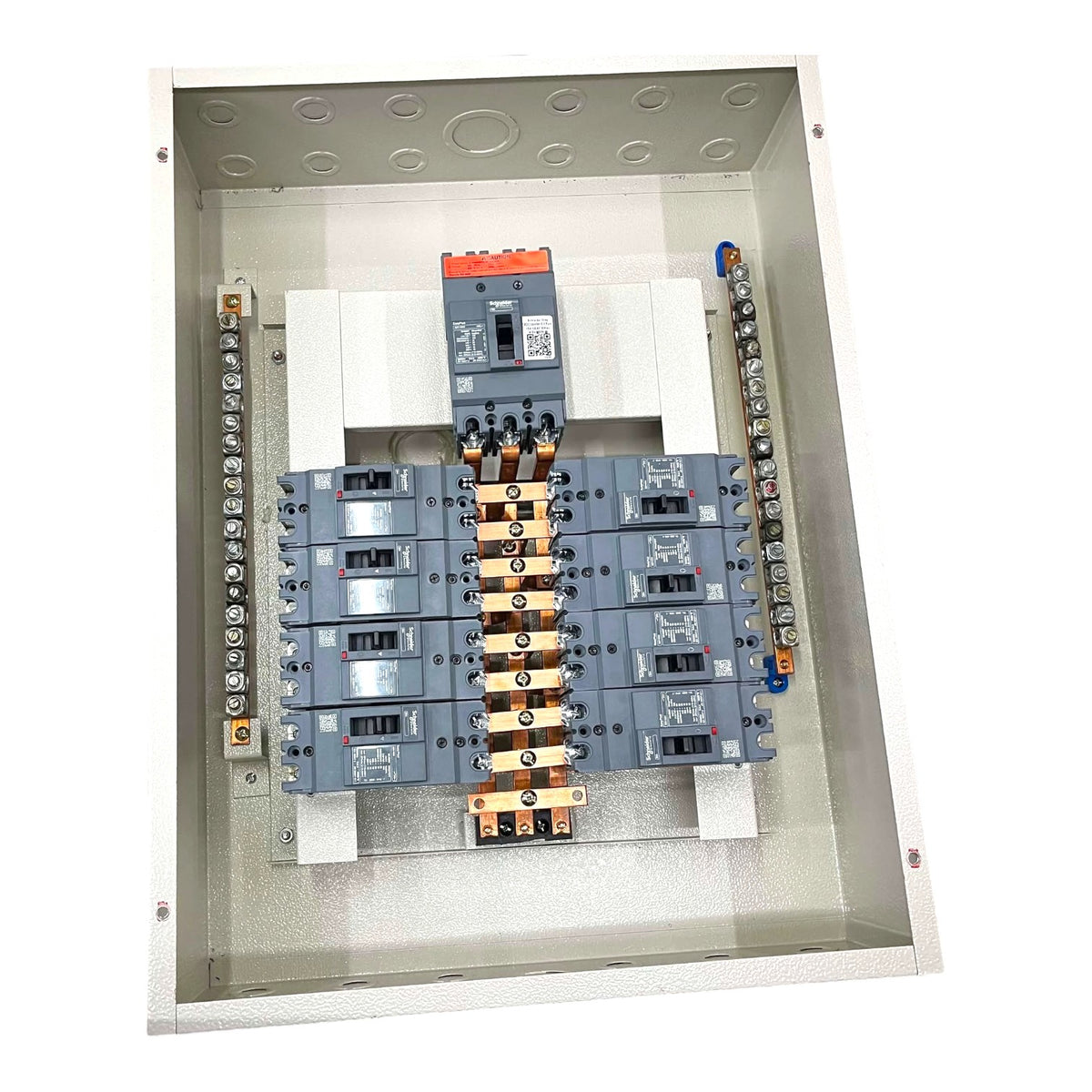 An open industrial electrical distribution panel showing multiple gray circuit breakers, terminal blocks, and a central busbar assembly inside a metal enclosure.