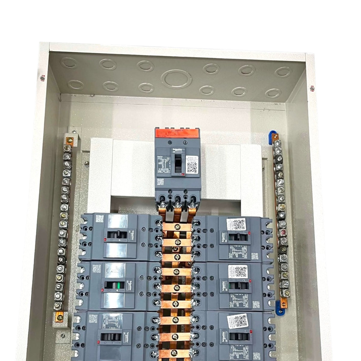An electrical panel featuring multiple circuit breakers, including a prominent orange-and-gray main breaker at the top and several gray breakers below, with copper bus bars and terminal strips on both sides.