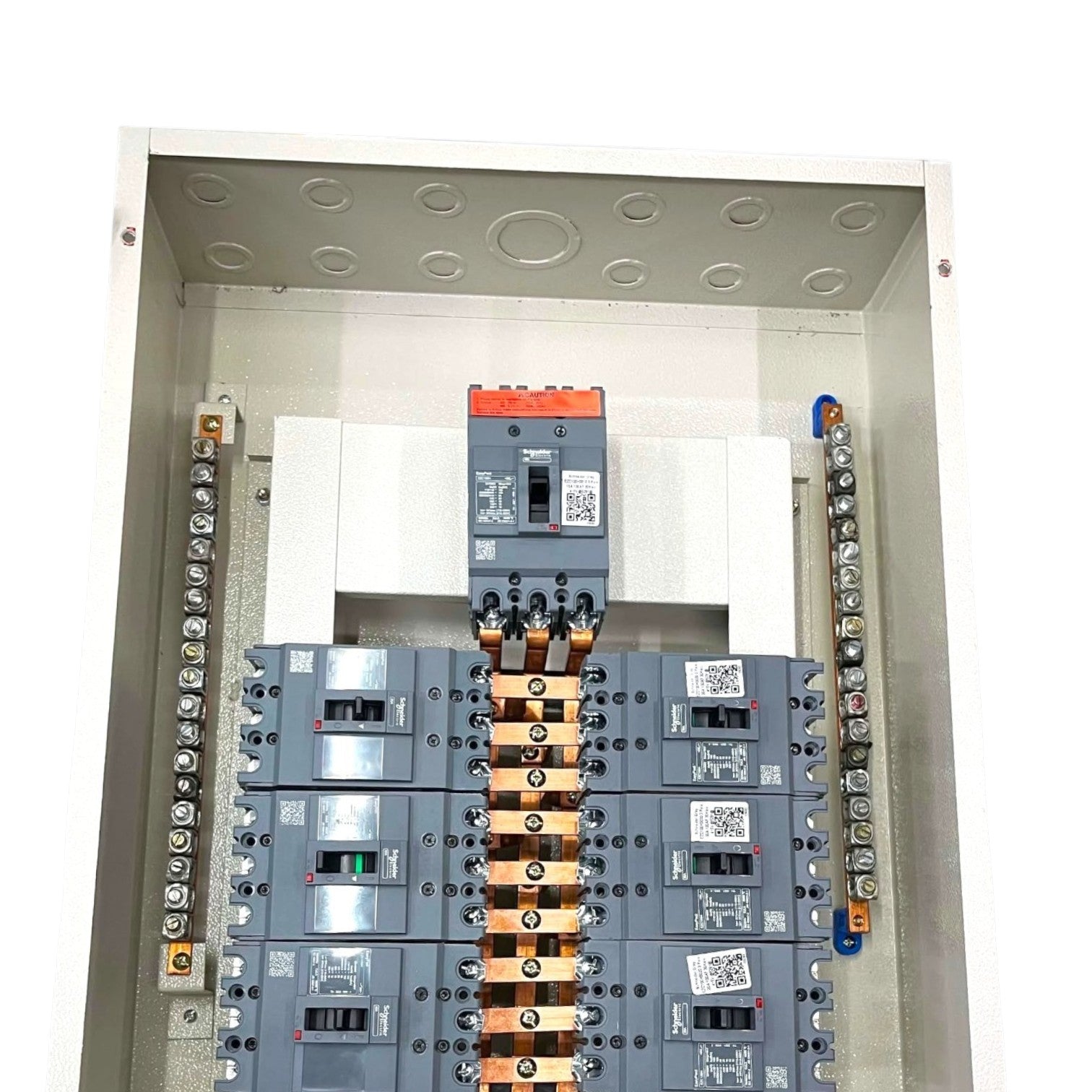 An electrical panel featuring multiple circuit breakers, including a prominent orange-and-gray main breaker at the top and several gray breakers below, with copper bus bars and terminal strips on both sides.