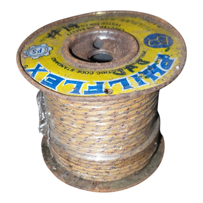 A spool of PHILIPLEX brand electrical wire, wound around a rusted metal core with a yellow and blue label, isolated on a white background.