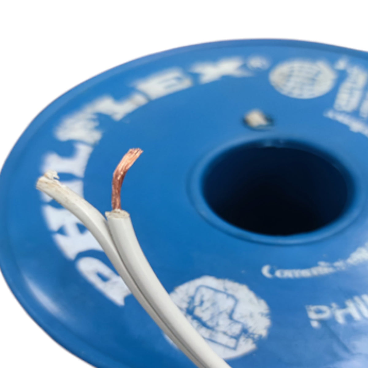 A close-up of a blue spool of white cable with two exposed white-wrapped wires showing copper-colored inner conductors. The spool has white printed branding text that appears to read 'BELLFLEX'.