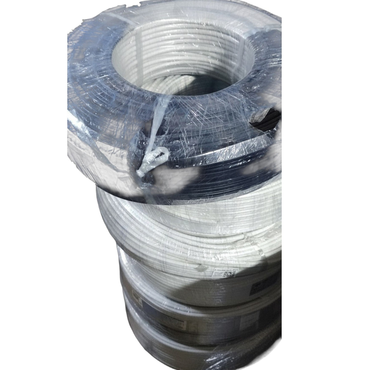 A stack of large industrial wire reels wrapped in clear protective plastic film, isolated on a white background.
