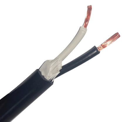 A close-up of a black electrical cable with its outer jacket peeled back to show the inner wires, including a white-insulated wire and a copper-colored stranded conductor.