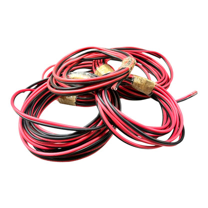 A coiled bundle of red and black electrical wires with gold-colored terminal connectors, isolated on a white background.
