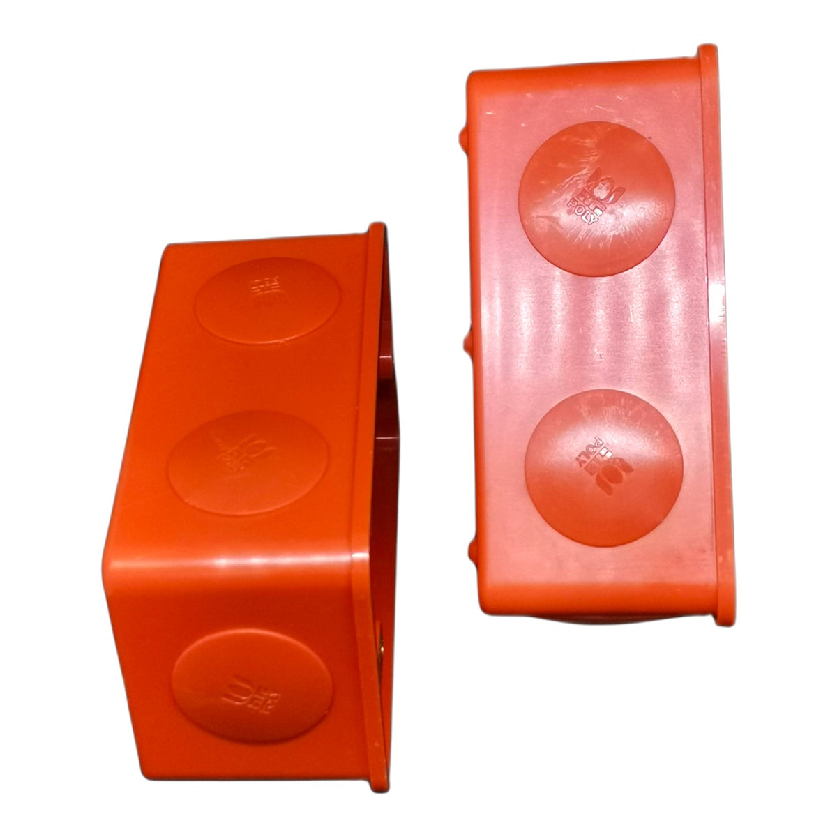 Two bright orange plastic electrical junction boxes shown from different angles on a white background.