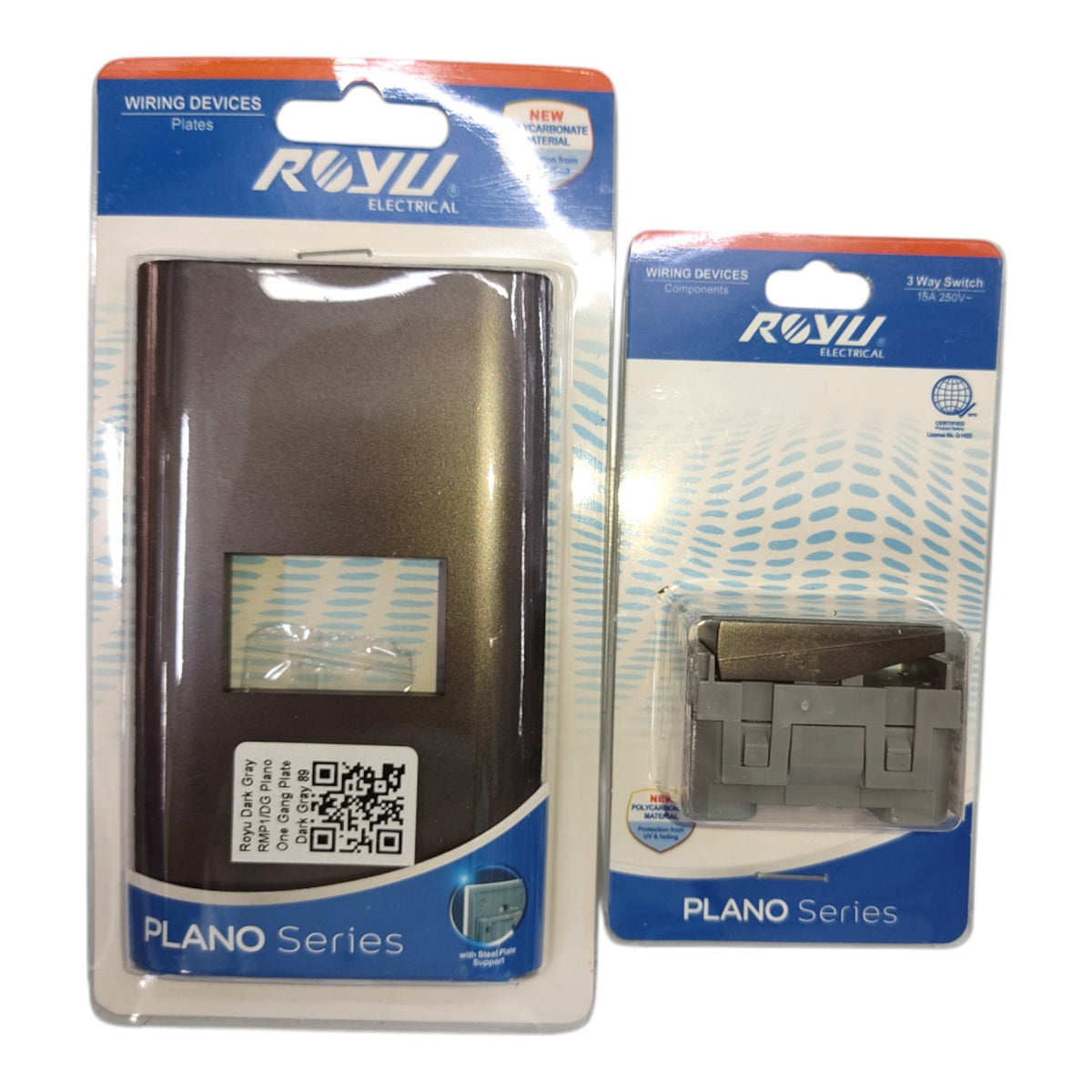 Two packaged ROVI Electrical piano series wiring devices on a plain white background: a larger black switch module in a tall package and a smaller gray 3-way switch module in a shorter package.