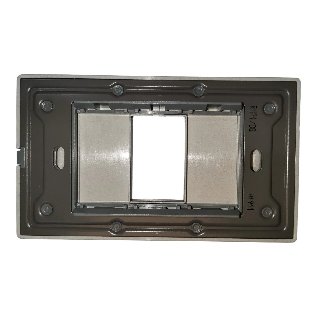 A metal electrical switch plate frame in a dark gray finish, featuring a central cutout with a brushed silver metallic insert and a blank white square in the middle.
