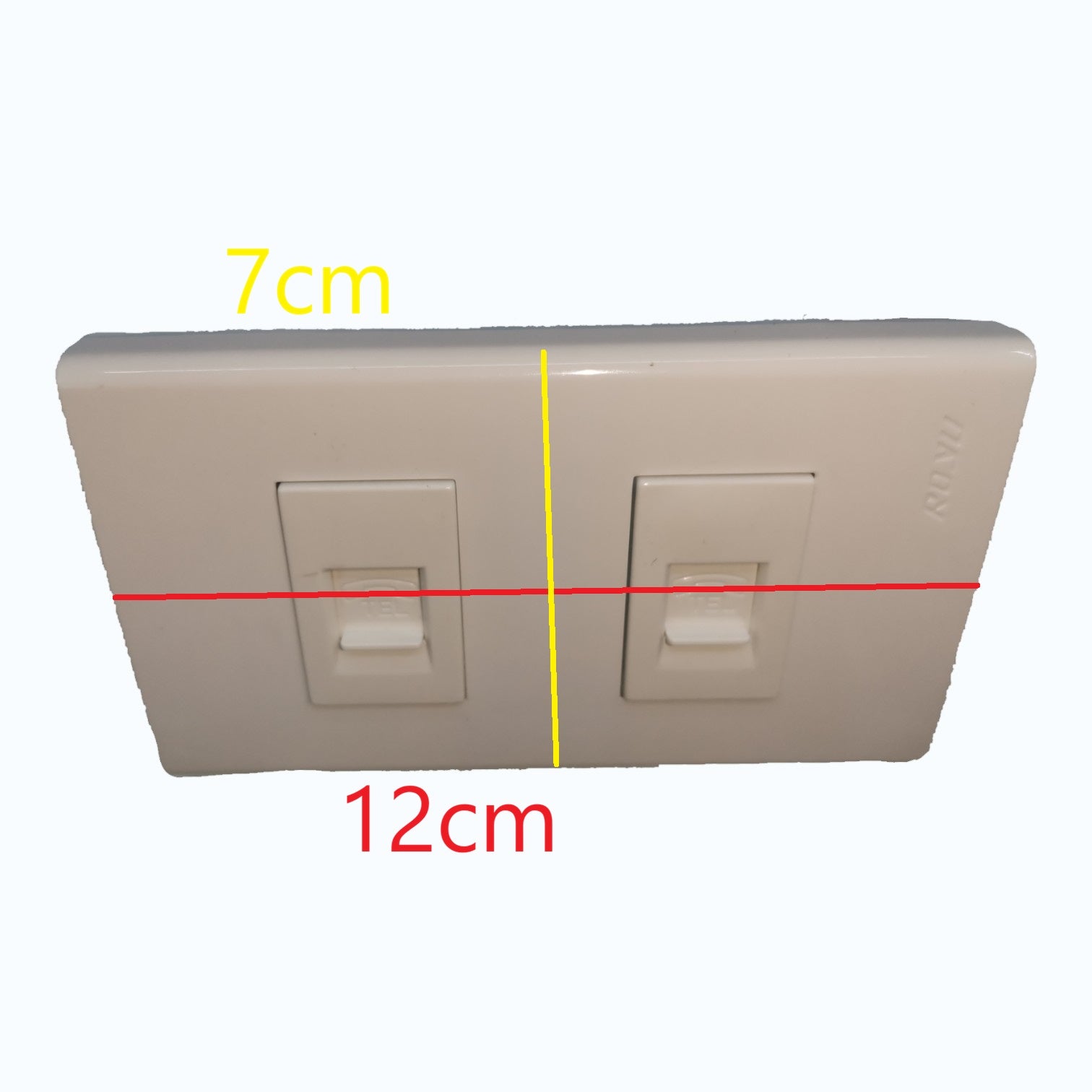A dual switch plate shown on a plain light background with overlaid dimension lines and text indicating 7 cm width, 12 cm height, and a yellow vertical center line.