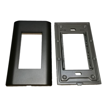 Two black plastic electrical outlet covers or faceplates shown side by side on a plain white background, one with a front cutout and one with mounting holes and printed markings.