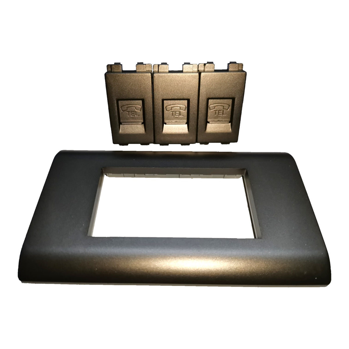 A black rectangular switch panel cover plate shown with three individual switch modules positioned above it on a plain white background.