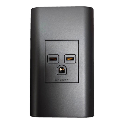 A dark gray rectangular power adapter or surge protector with a built-in three-prong outlet and two USB-C ports on the front, shown against a plain white background.
