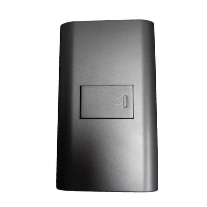 A dark gray rectangular replacement battery cover with a recessed power button symbol, shown on a plain white background.