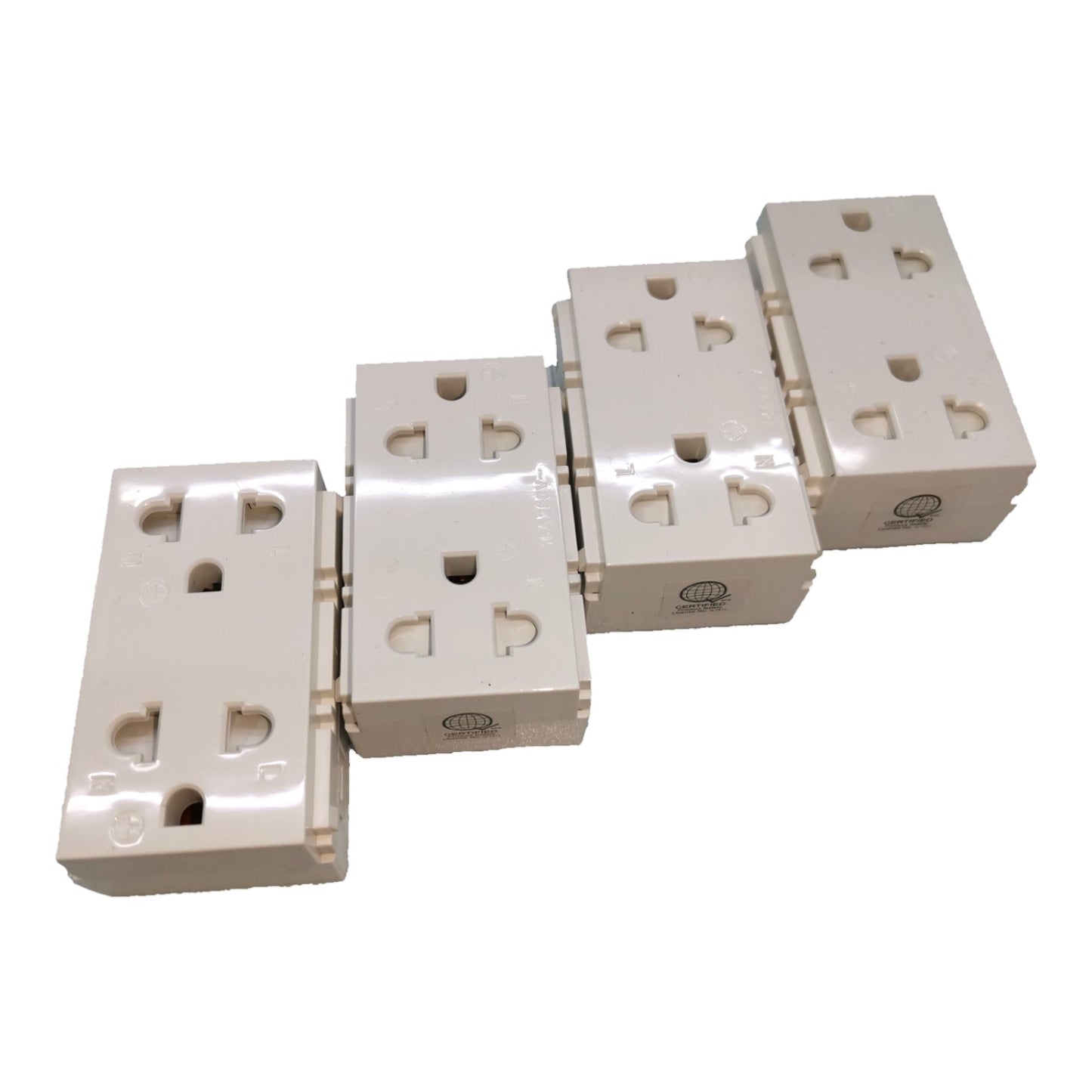 Four cream-colored plastic multi-socket wall outlets arranged diagonally on a plain white background.