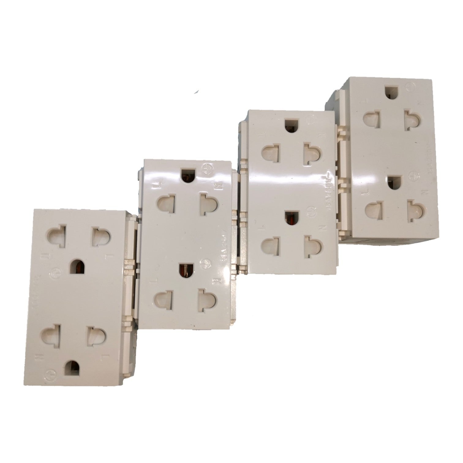 Four beige plastic multi-socket wall outlets arranged diagonally on a plain white background.