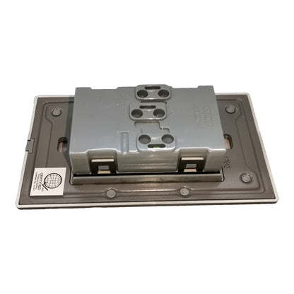 A gray plastic electrical outlet cover plate with a metal backplate and a small white sticker on the left side, shown on a plain white background.