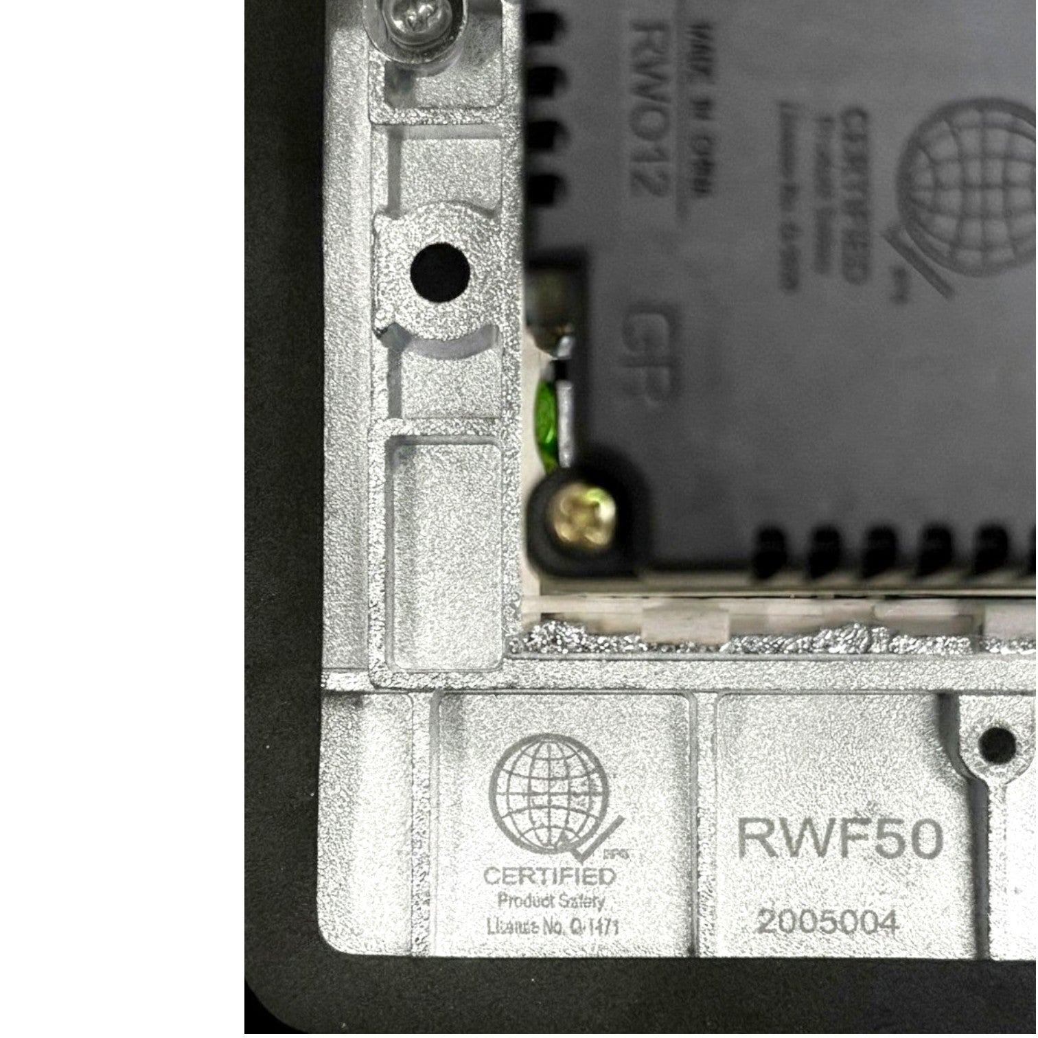 Close-up of a metallic industrial electronic component with printed text including 'RWF50', 'Certified Product Safety', and 'Made in Germany'.