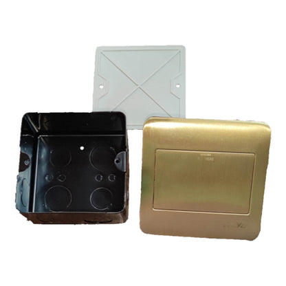 A set of electrical junction box components on a white background, including a black metal box with circular terminal holes, a brushed gold metal cover plate, and a white plastic cover cap.