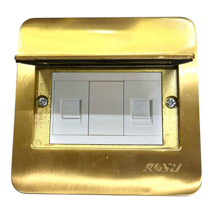 A three-button indoor light switch plate in a brushed gold metal finish with a hinged cover open, revealing white switch buttons. The brand name 'RAJ' is visible in the bottom right corner of the gold plate.