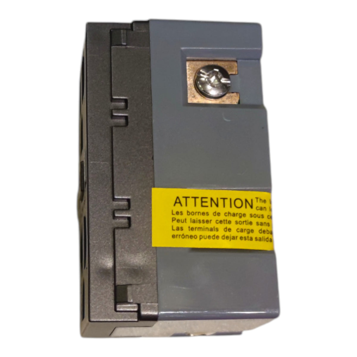 A gray electrical terminal block with a yellow warning label in Spanish and French, featuring a brass screw terminal on the top, isolated on a white background.