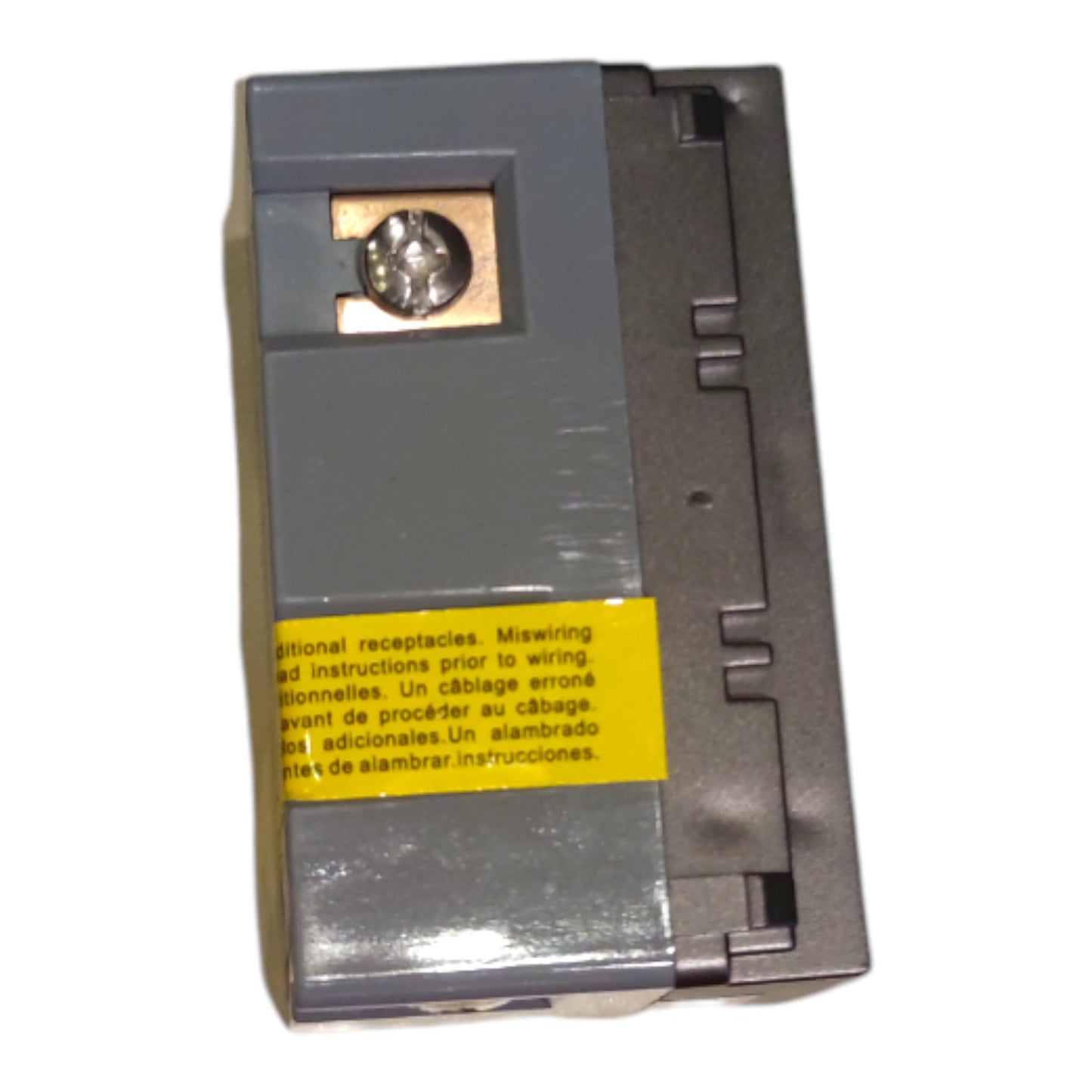 A gray electrical receptacle module with a yellow warning label and a metal screw terminal, photographed on a plain white background.