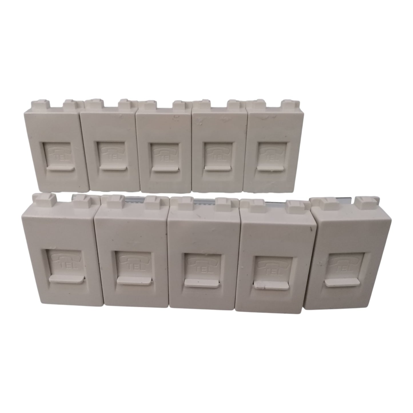 Ten light gray toy building block pieces arranged in two rows on a plain white background.