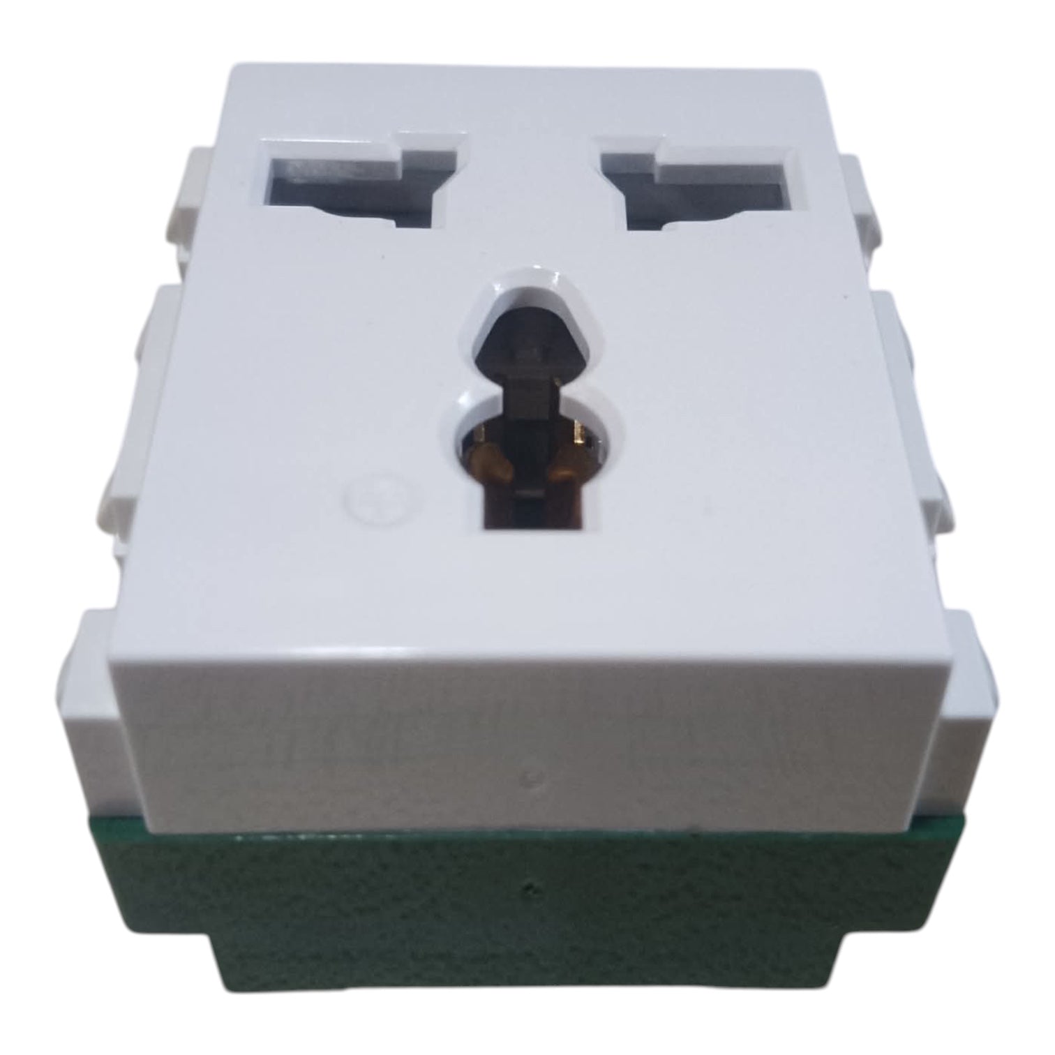 A white plastic multi-socket wall outlet module with a green base, featuring two UK-style three-pin sockets on top and a central keyhole-shaped opening.