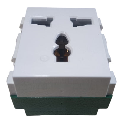 A white plastic multi-socket wall outlet module with a green base, featuring two UK-style three-pin sockets on top and a central keyhole-shaped opening.