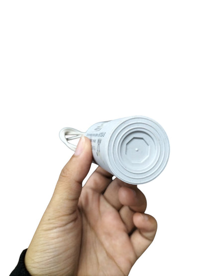 Front view of Syscap 12uF 450V motor running capacitor held in hand for electrical applications