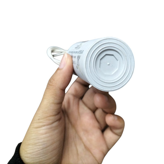 Syscap 15MFD motor running capacitor held in hand for easy installation and operation