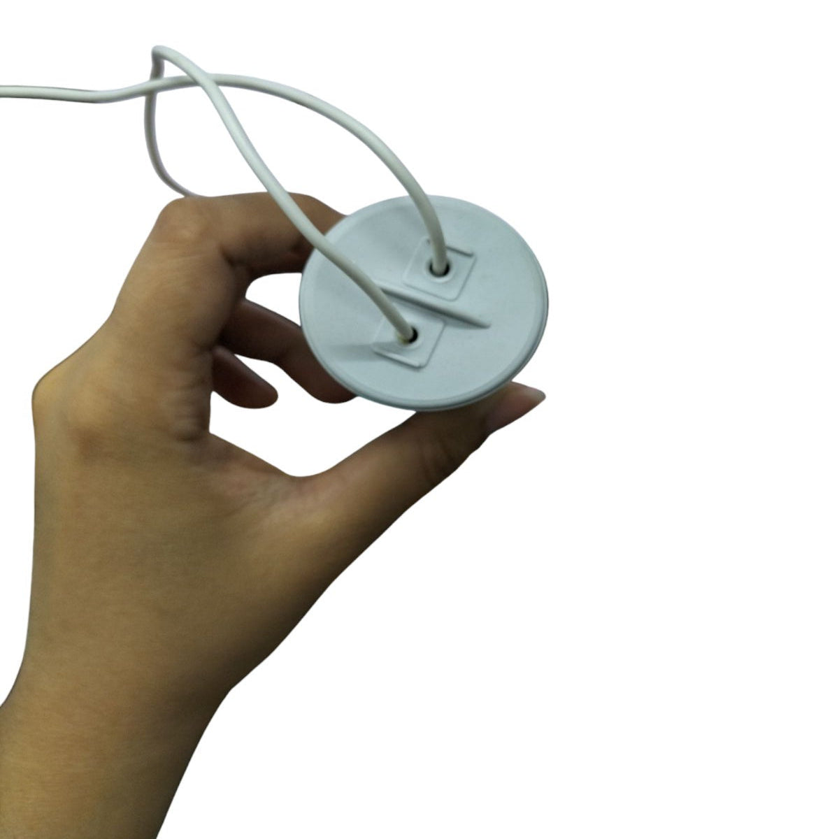 Hand holding SYSCAP motor running capacitor 8MFD 600V AC with white wires attached