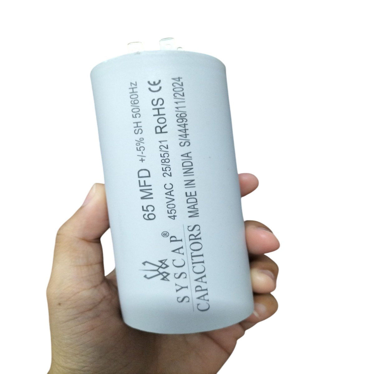 Hand holding SYSCAP Motor Running Capacitor 65MFD 450V AC electrical component for motors
