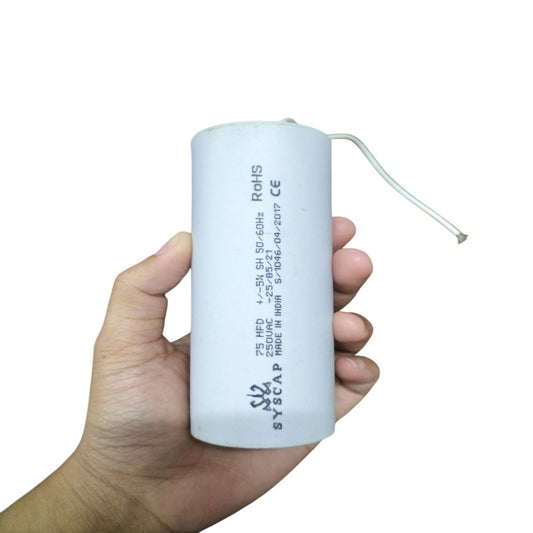 Hand holding SYSCAP 75mfd 250V AC Motor running capacitor white cylindrical electrical component