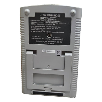 Back view of a gray electronic device with warning label on a white  Sanwa Analog Multi-Tester Capacitance Tester CX506a Capacitance Range 2000uF Made in Japan Electx Electrical Supplybackground