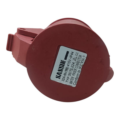 Red electrical connector with a label on a white background