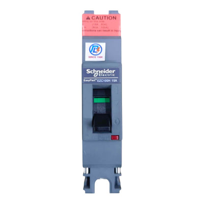 Schneider Electric EasyPinH EZC100H 15A modular circuit breaker with a gray housing, black switch, green indicator, and red warning label.