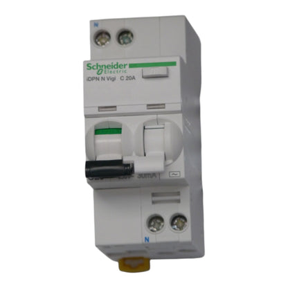 Schneider Electric DPN N Vigi C 20A modular circuit breaker, white plastic housing with green brand logo, black switch handle, and yellow terminal connector at the bottom, isolated on a white background.