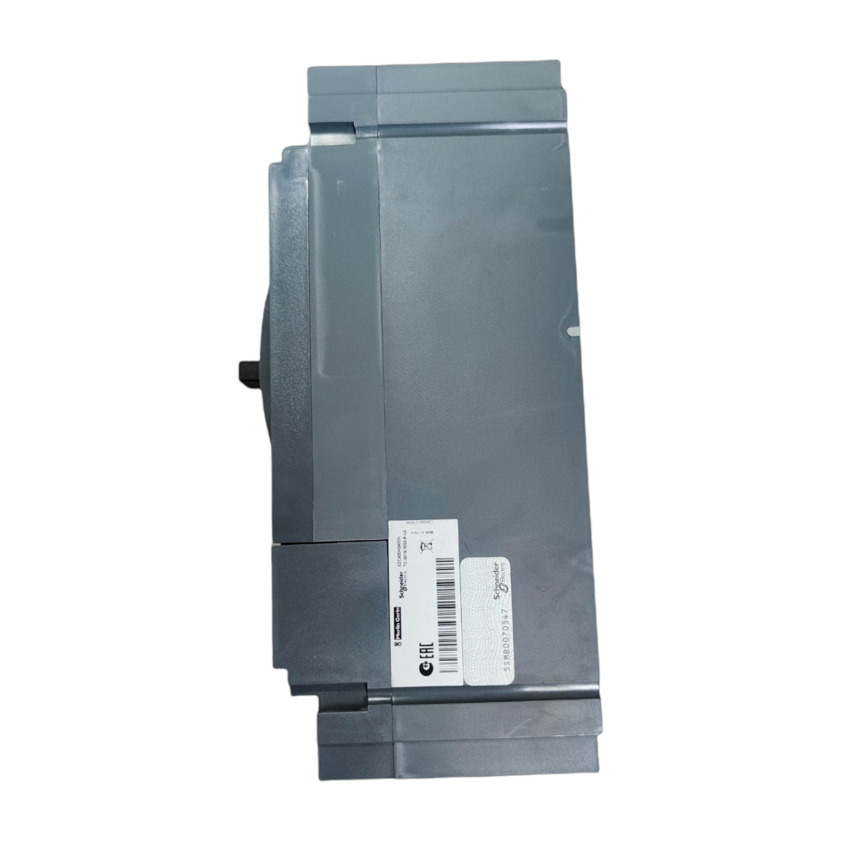 A gray industrial electronic module or control panel component with a white barcode label on the front, shown against a plain white background.