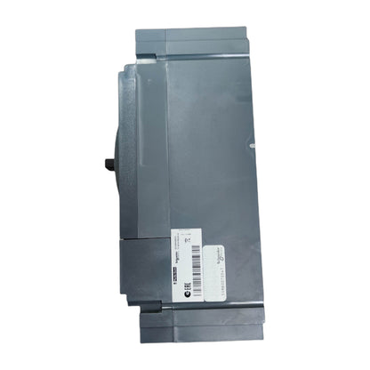A gray industrial electronic module or control panel component with a white barcode label on the front, shown against a plain white background.