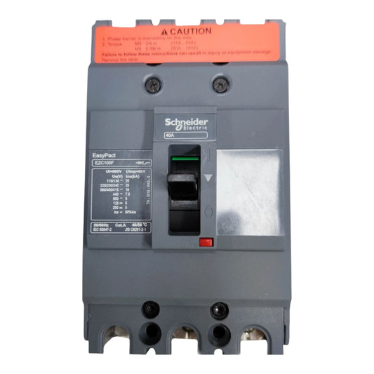 Schneider Electric EasyPad EBC1600F circuit breaker in dark gray plastic with an orange caution label on top, a black switch, and a silver terminal cover, shown on a white background.