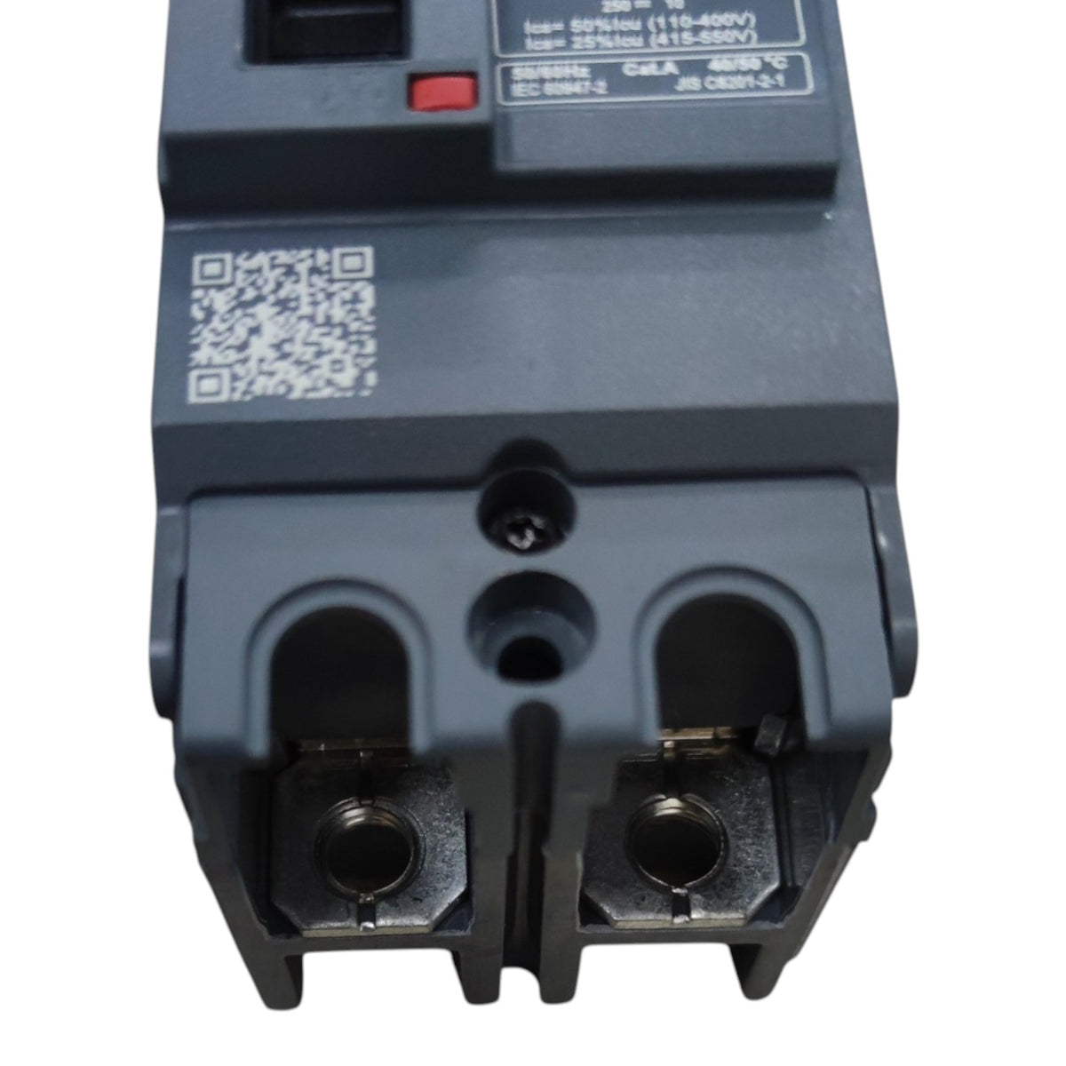A close-up of a dark gray electrical circuit breaker component with terminal connectors, a QR code, and printed technical specifications on the top surface, isolated on a white background.