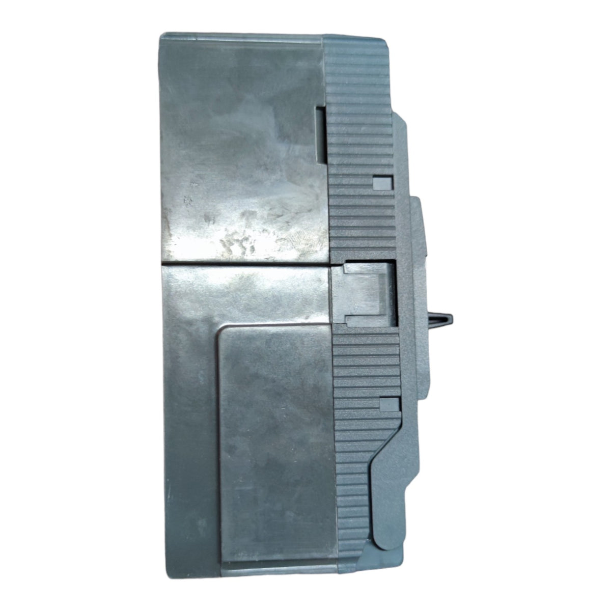 A gray plastic or metal mechanical component with a ribbed side and a small protruding pin, shown against a plain white background.