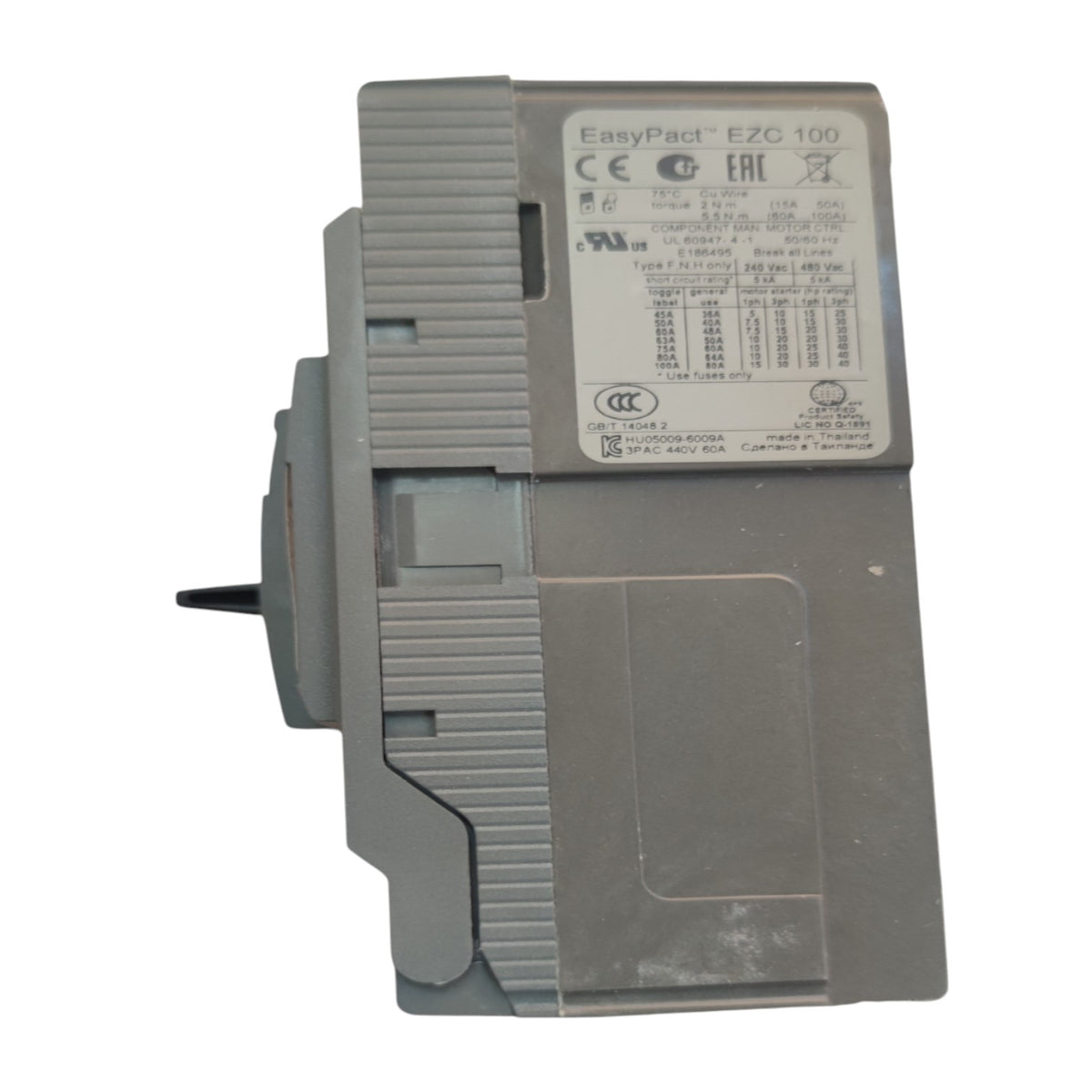 A gray EasyPact E2C 100 electronic module with a white technical specification label, photographed on a white background.