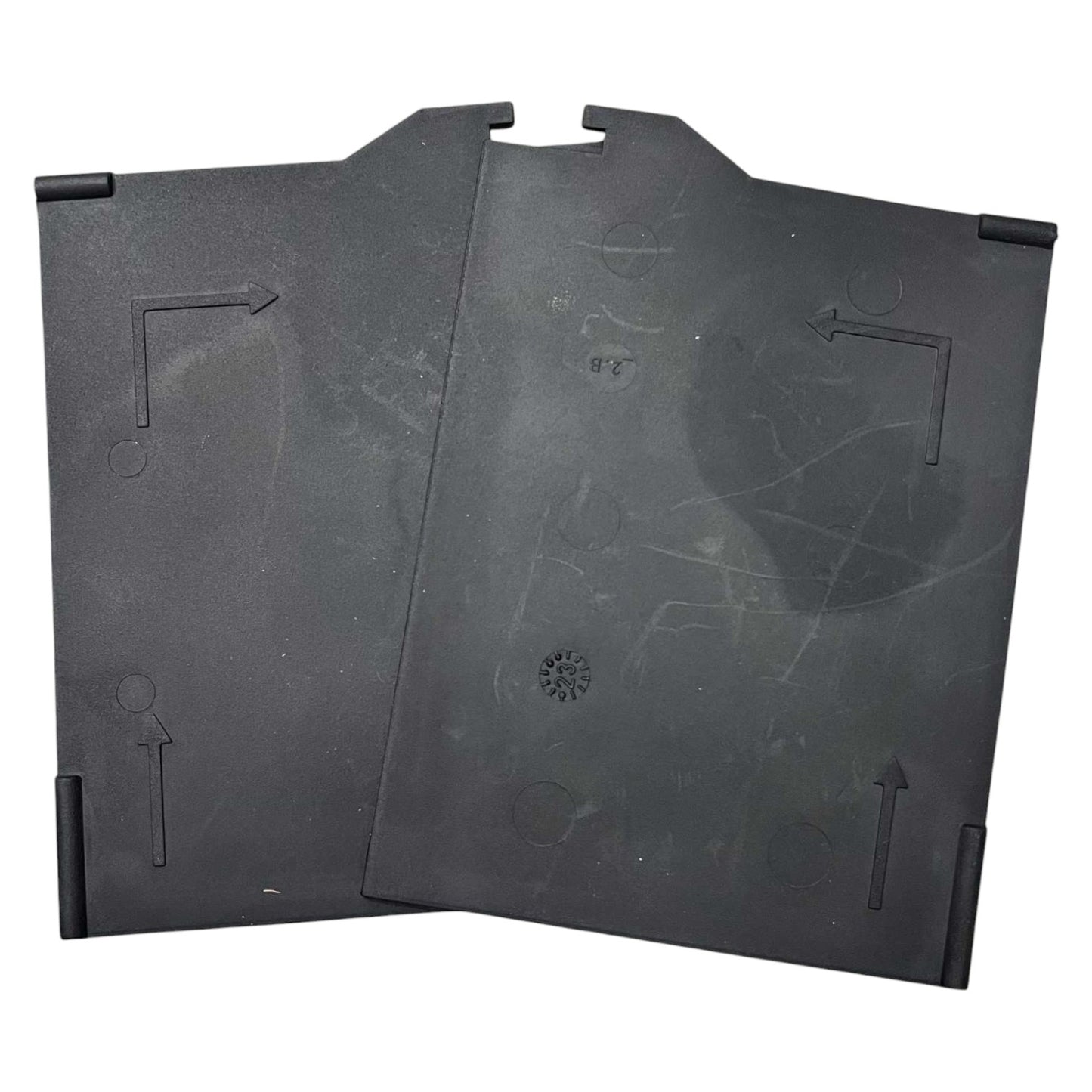 Two black plastic trays with embossed patterns on a white background